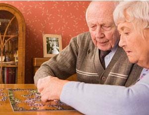 Elderly couple working on a puzzle
